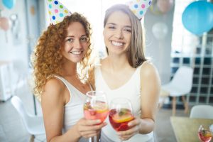 A group of friends enjoying a lively party with drinks and laughter.