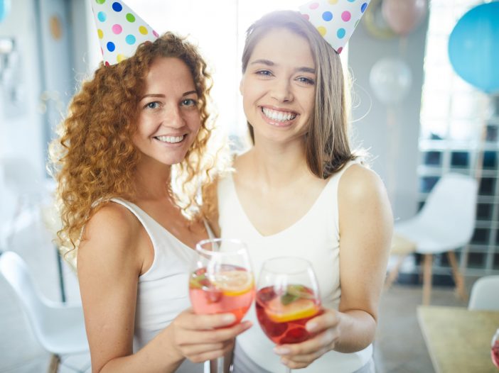 A group of friends enjoying a lively party with drinks and laughter.