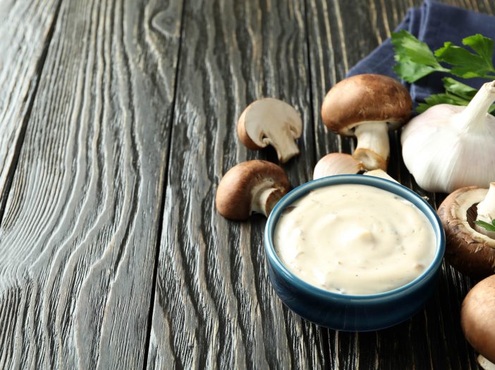 Pasta topped with creamy portobello mushroom sauce, garnished with fresh herbs