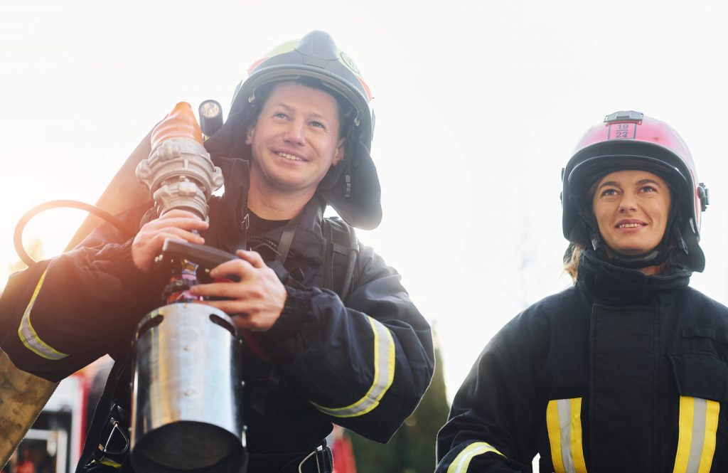 Firefighter conducting a safety inspection at an outdoor wedding venue with fireworks.